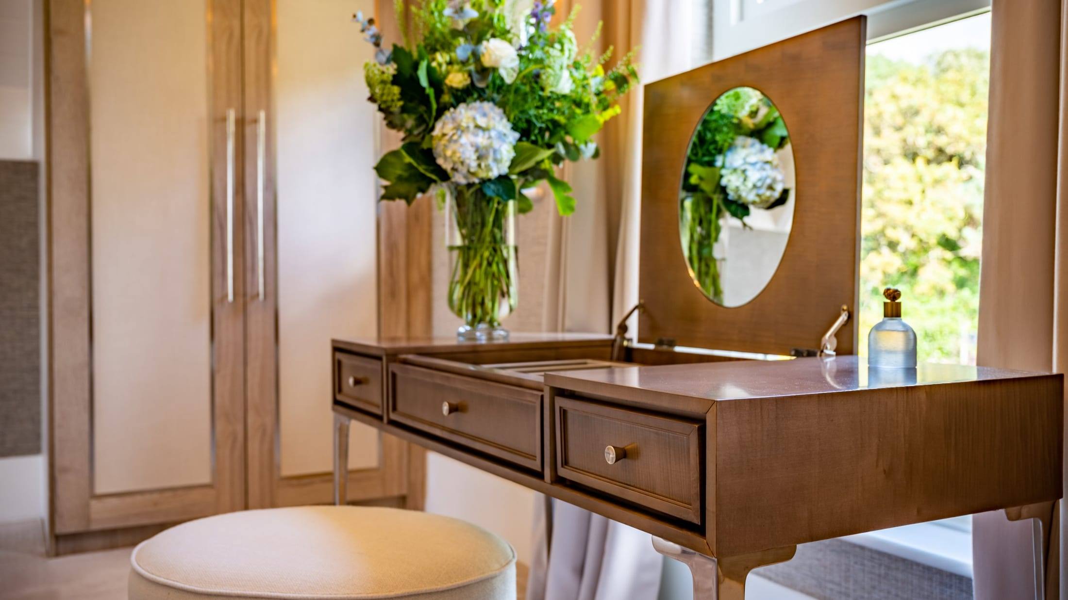 Handmade veneered dressing table with a flip-up mirror, three drawers and polished metal legs